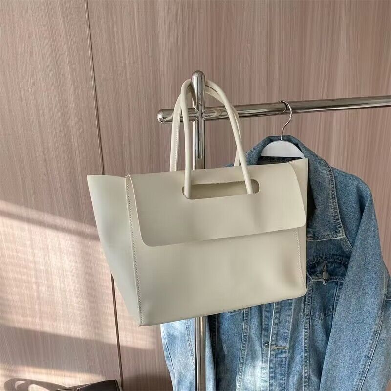 White Structured Flap Tote hanging on a rack