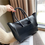 Black Structured Flap Tote held by the handles
