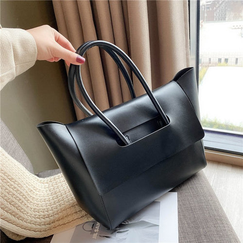 Black Structured Flap Tote held by the handles