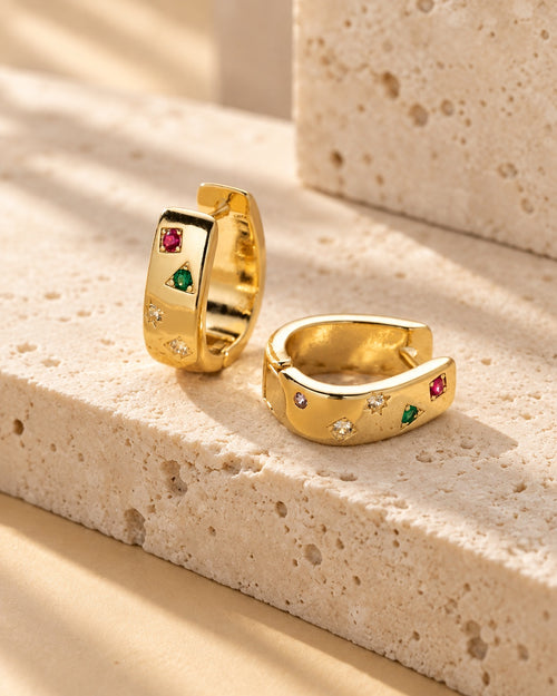 Gold-tone mini huggie hoop with multicolor square zircon stones on textured warm stone