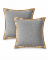 Gray linen pillow covers with jute trim on a white background