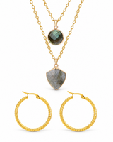 Layered stone pendant necklace and embossed gold-tone hoops on a white background