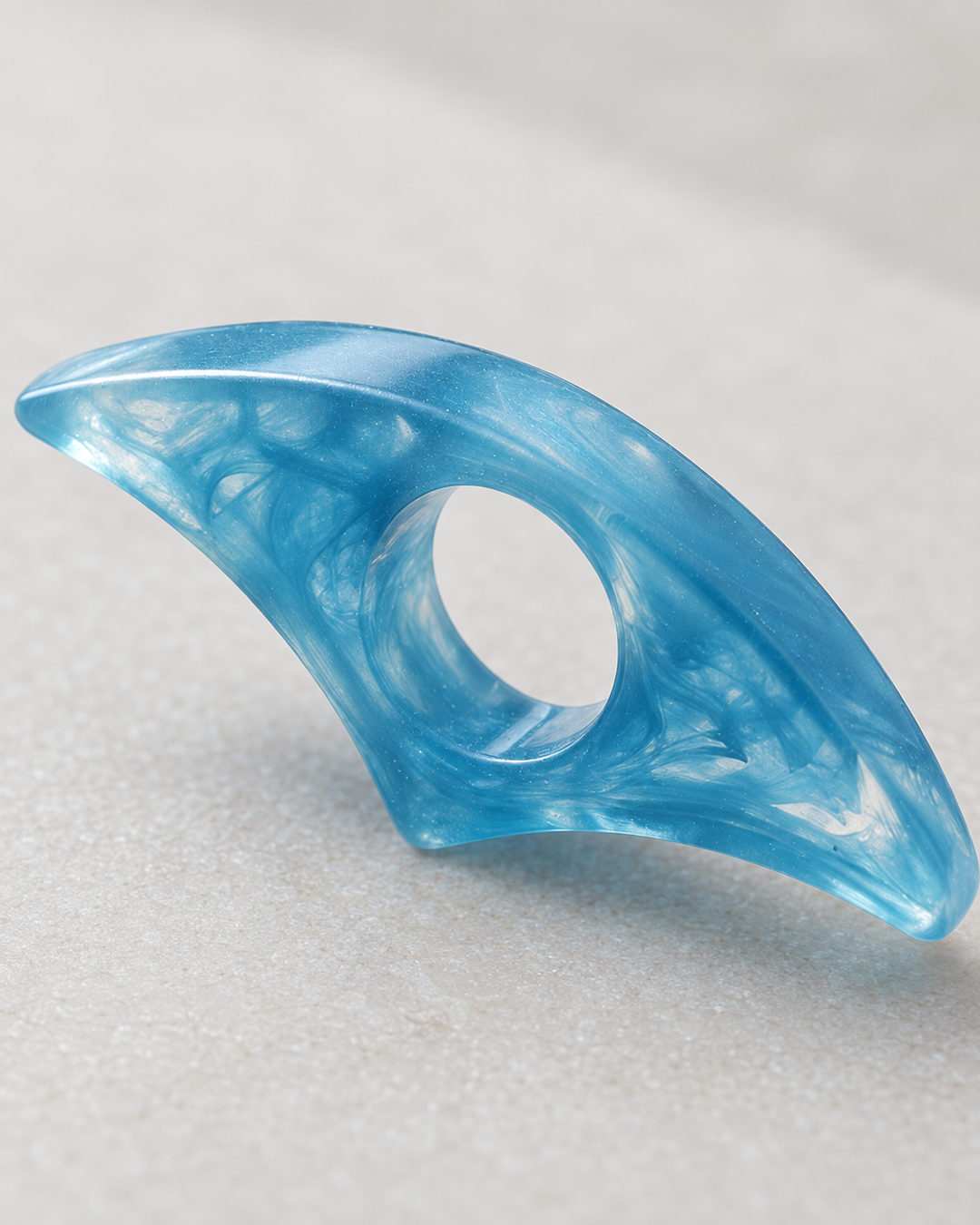 Close-up detail of the blue resin thumb page holder