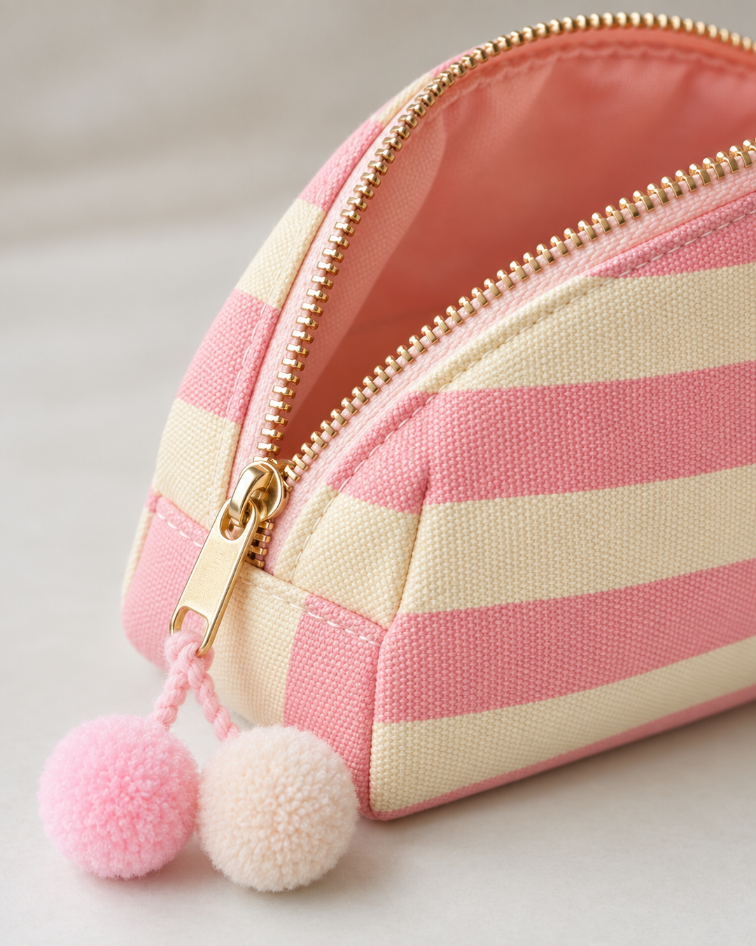 Close-up detail of the pink striped canvas pouch