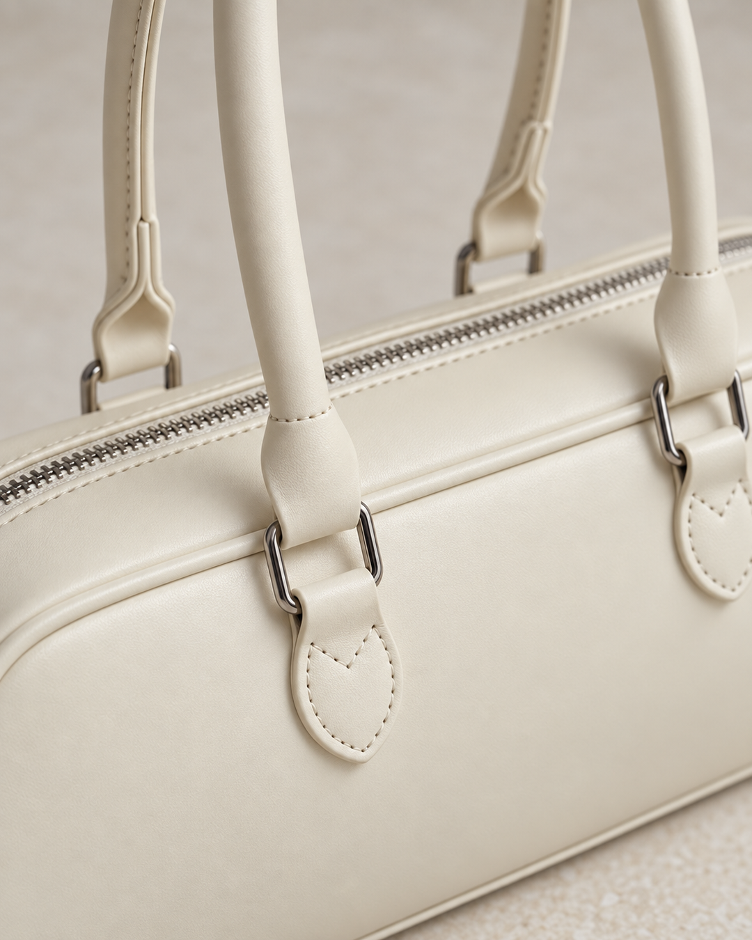 Close-up detail of the cream baguette bag