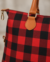 Close-up detail of the red buffalo check weekender bag