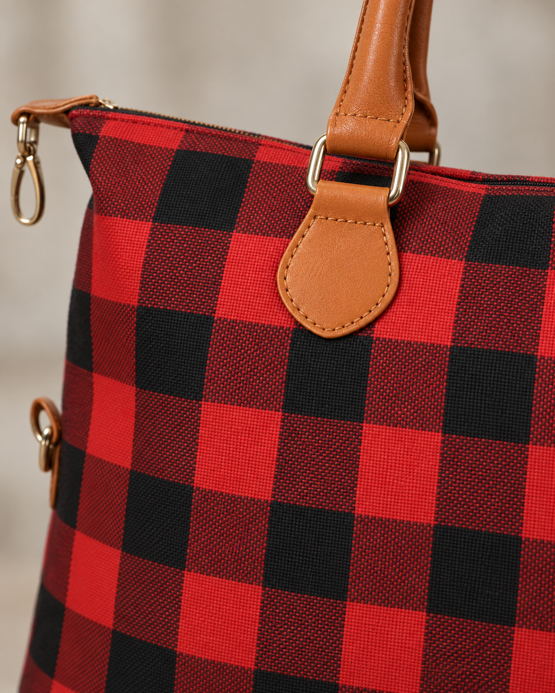 Close-up detail of the red buffalo check weekender bag