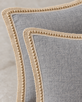 Close-up detail of the gray linen pillow covers with jute trim