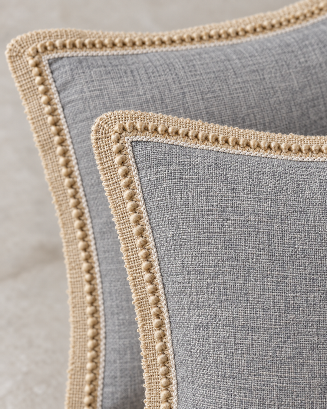 Close-up detail of the gray linen pillow covers with jute trim