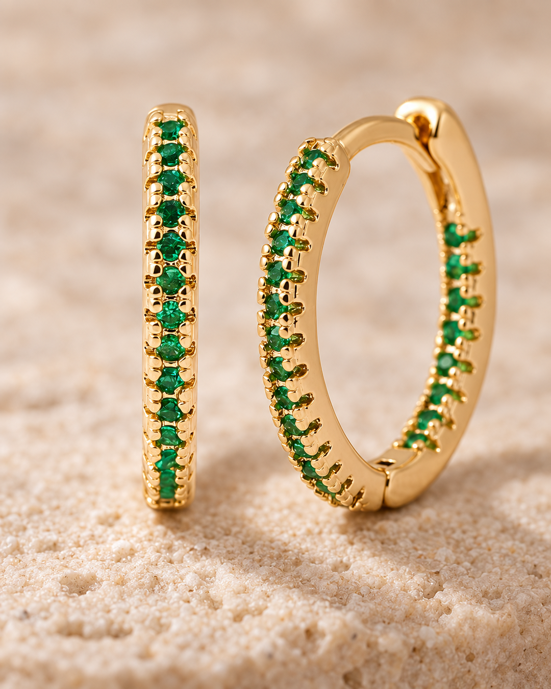 Close-up detail of the gold-tone green stone mini hoop earrings