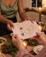 Layered stone pendant necklace and embossed gold-tone hoops handed to Mom at a holiday dinner