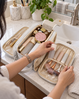 Hanging toiletry bag packed with travel bottles on a bathroom counter