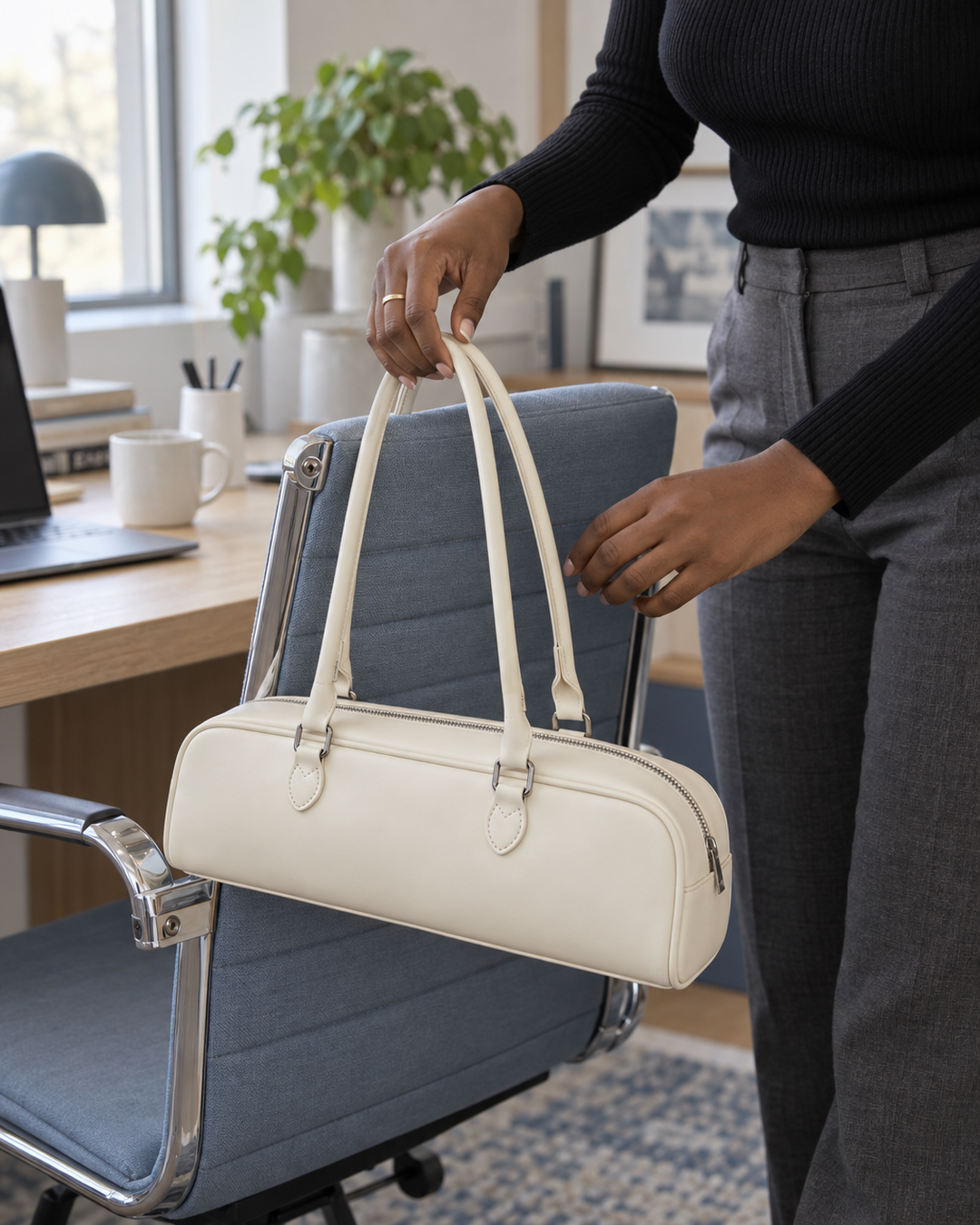 Cream baguette bag hung on a desk chair at the office