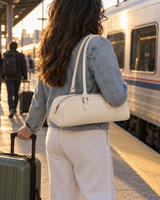 Cream baguette bag carried on the shoulder on a train platform