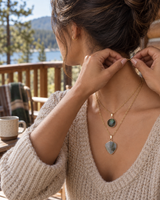 Layered stone pendant necklace worn on a cabin porch getaway